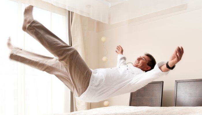 Упала на постель. Человек прыгает на кровати. Человек падает на кровать. Прыжки на кровати. Прыгать на кровати в отеле.
